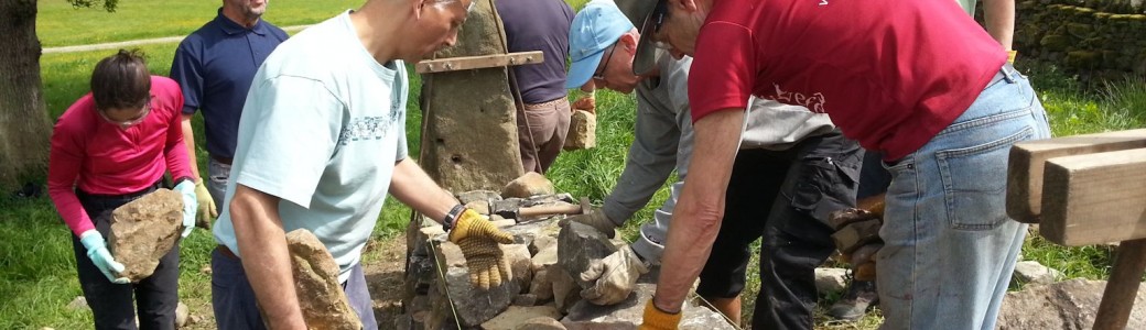 A group of people repairing/building a dry stone wall